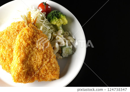 Fried horse mackerel photographed against a black background 124738347
