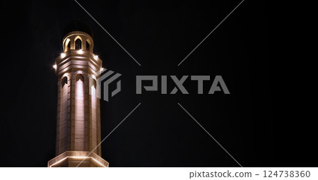 Mosque minaret with lights at night with copy space Mosque minaret with lights at night with copy space 124738360