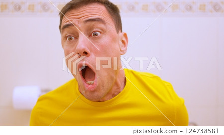 Man achieving long awaited goal while sitting on toilet 124738581