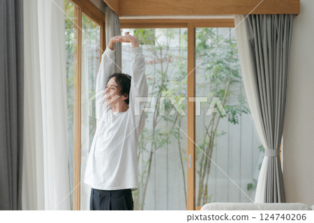 A man looking out the window 124740206
