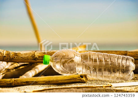 Plastic empty water bottle abandoned on nature 124743359