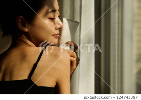 Skin care image of a young woman photographed in warm tones 124743387