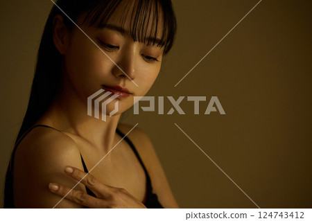 Skin care image of a young woman photographed in warm tones 124743412