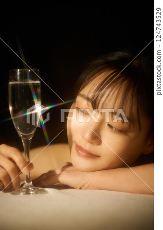 Beauty image of a young woman photographed in warm tones 124743529