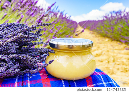 Jar with honey and lavender flowers. 124743885