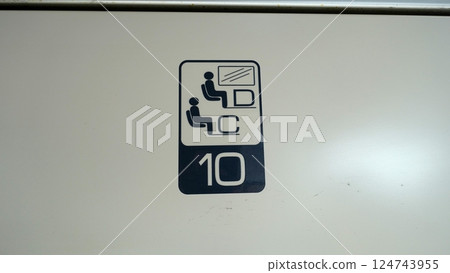 Directions for a numbered seat in a train compartment. Directions for a numbered seat in a train compartment. 124743955