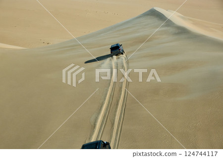 Cars speeding in a desert 124744117