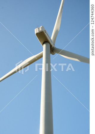 Wind turbine with blue sky at background 124744360