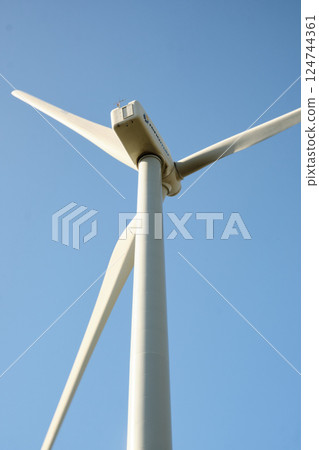 Wind turbine with blue sky at background 124744361