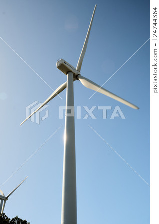 Wind turbine with blue sky at background 124744364