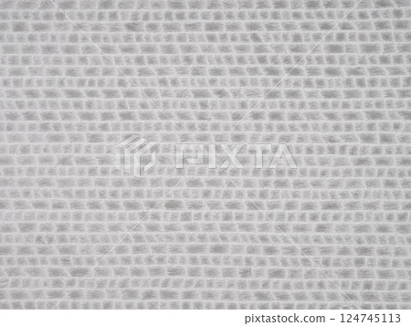 The soft, woven texture of bleached oak veneer displays a grid of pale dove and alabaster, an epitome of Scandinavian design 124745113