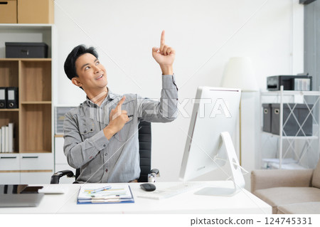 Happy mature businessman presenting or pointing, happy working. Happy mature businessman presenting or pointing, happy working. 124745331