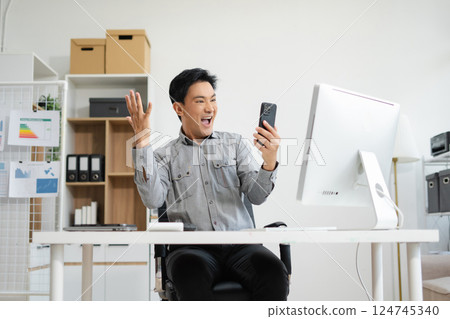asian businessman are excited business success with inspiration from their excellent financial results that are happy working in a modern office on a computer. asian businessman are excited business success with inspiration from their excellent financial results that are happy working in a modern office on a computer. 124745340