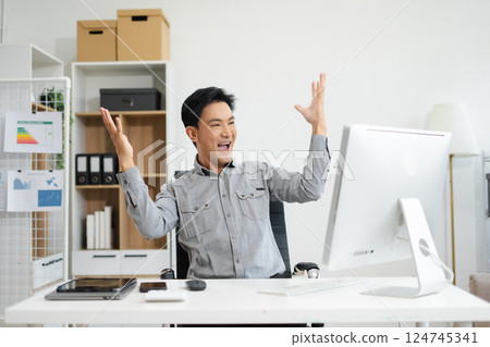 asian businessman are excited business success with inspiration from their excellent financial results that are happy working in a modern office on a computer. 124745341