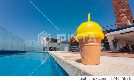 Ice cream cup by the pool on a summer day 124745658