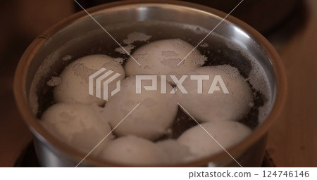 Boiled eggs in a pot with bubbling water for cooking organic eggs Boiled eggs in a pot with bubbling water for cooking organic eggs 124746146