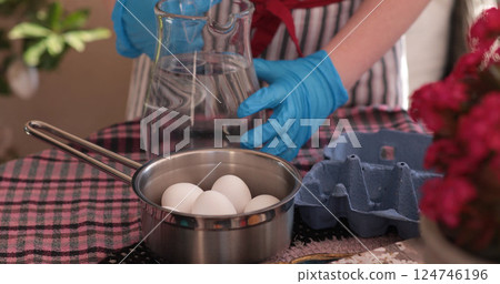Preparing Easter eggs for coloring, boiling eggs for decoration and family fun during the holiday season Preparing Easter eggs for coloring, boiling eggs for decoration and family fun during the holiday season 124746196