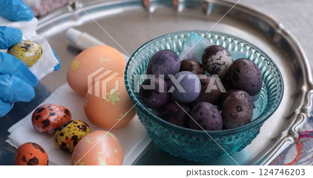 Vibrant Easter eggs and quail eggs adorned with pearl paint ready for celebration 124746203