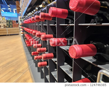 red Wine bottles close-up in winery. wine bottles on the wine rack. Bottles without labels in rows in the wine cellar. red Wine bottles close-up in winery. wine bottles on the wine rack. Bottles without labels in rows in the wine cellar. 124746385