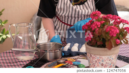 Coloring eggs for Easter eggs celebration with vibrant colors and creative patterns in a cozy outdoor setting Coloring eggs for Easter eggs celebration with vibrant colors and creative patterns in a cozy outdoor setting 124747056