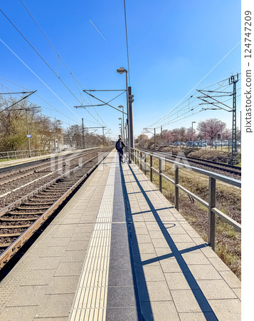 Person with Bike on Empty Train Platform, Sunny Day, Public Transportation, Travel. High quality photo Person with Bike on Empty Train Platform, Sunny Day, Public Transportation, Travel. High quality photo 124747209