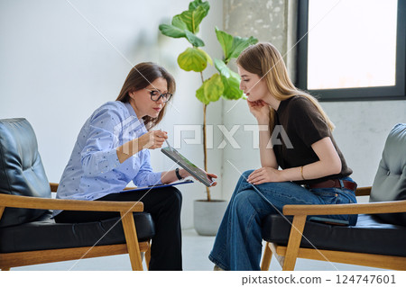 Mental therapy, female professional psychologist working with young woman patient Mental therapy, female professional psychologist working with young woman patient 124747601