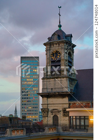 Evening in Brussels. Belgium. The clock tower of the church of Saints John and Stephen the Minimes aka the Church of the Minimes near Athenee Robert Catteau Evening in Brussels. Belgium. The clock tower of the church of Saints John and Stephen the Minimes aka the Church of the Minimes near Athenee Robert Catteau 124748014