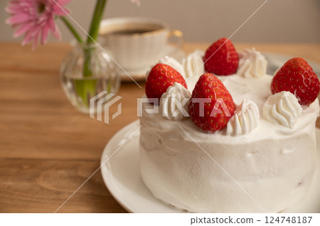 A whole strawberry shortcake on a table 124748187