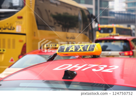 Dubai, UAE - September 27, 2024 Taxi sign on the roof of a car against the backdrop of city traffic, close-up. Editorial 124750752