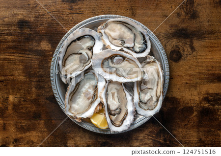 Fresh raw oysters on ice, overhead flat lay shot Fresh raw oysters on ice, overhead flat lay shot 124751516