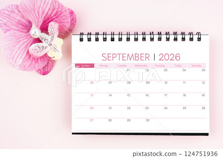 Desk calendar for September 2026 with pink orchid. Flat lay. Desk calendar for September 2026 with pink orchid. Flat lay. 124751936