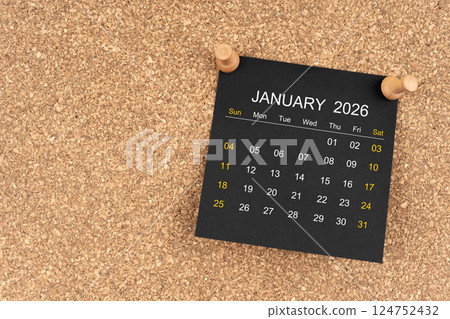 Black calendar sheet for January 2026 with thumbtack on wooden board. 124752432
