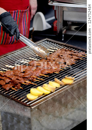 Chef Grilling Meat Skewers With Tongs Chef Grilling Meat Skewers With Tongs 124752484