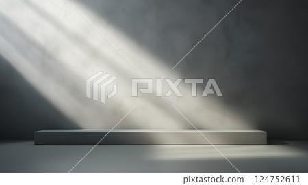 Minimalist empty podium with soft natural light beams and dark wall background for product display or art showcase 124752611