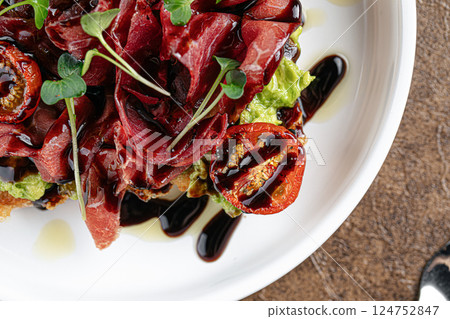 Gourmet prosciutto toast with avocado and balsamic 124752847