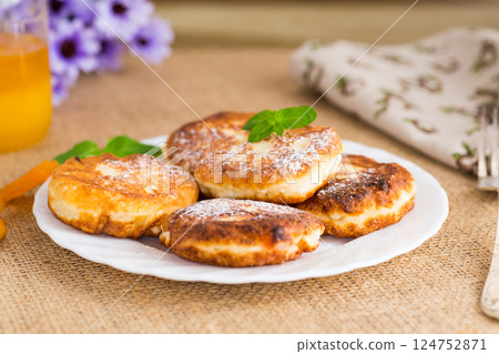 Cottage cheese pancakes with dried apricots and honey on a wooden table Cottage cheese pancakes with dried apricots and honey on a wooden table 124752871