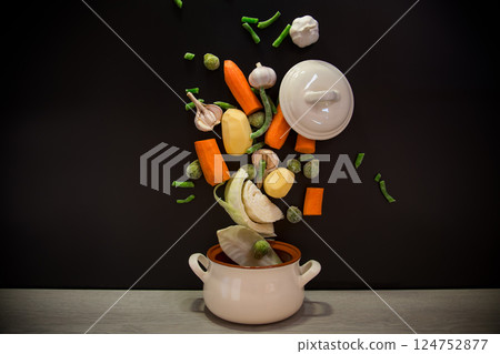 Vegetables in motion before cooking in soup Vegetables in motion before cooking in soup 124752877