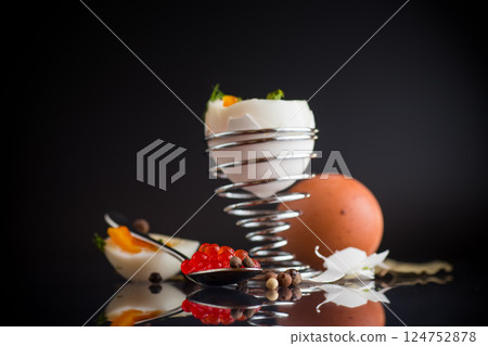 delicacy with red caviar and boiled egg for breakfast, isolated on black background delicacy with red caviar and boiled egg for breakfast, isolated on black background 124752878