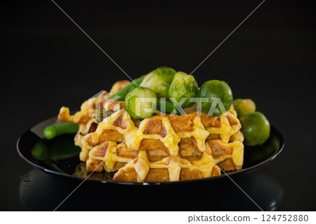 Vegetable waffles with brussel sprouts and green beans, isolated on black background 124752880