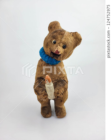Vintage worn broken wind-up teddy bear with a bottle, isolated on a white background Vintage worn broken wind-up teddy bear with a bottle, isolated on a white background 124752975