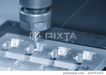 The CNC milling machine high precision cutting aluminum jig part by solid flat nose end mill tool in the light blue scene. 124753472