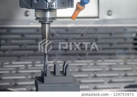The CNC milling machine cutting the graphite electrode parts with solid flat nose end mill tool. The CNC milling machine cutting the graphite electrode parts with solid flat nose end mill tool. 124753473