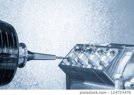 The 5-axis CNC milling machine cutting the aluminum engine block by solid ball nose end mill tool in the light blue scene. 124753476