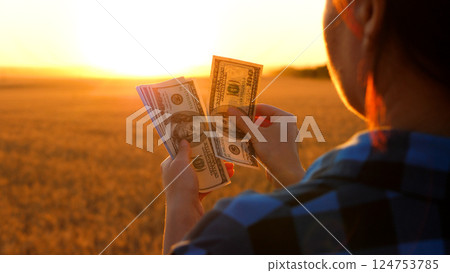 Farmer holding money in hands, counting profit from selling crops. Agriculture income. Farming economy, agricultural profitability, agribusiness growth. Farmer holding money in hands, counting profit from selling crops. Agriculture income. Farming economy, agricultural profitability, agribusiness growth. 124753785