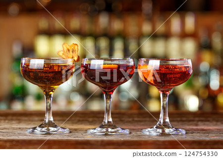 Different cocktails stand in a row Different cocktails stand in a row 124754330