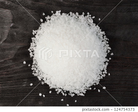 Sea salt on a wooden table. 124754373