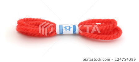 Red thread bracelet isolated on white. 124754389