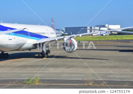 Parked aircraft with engine covers 124755174