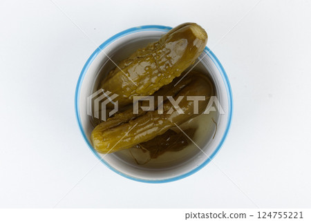 Top view of pickles with brine in a bowl. 124755221