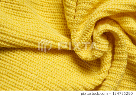 Knitted clothes. Waves of yellow fabric with a knitting pattern. Textiles. Banner for advertising goods for creativity. Knitted clothes. Waves of yellow fabric with a knitting pattern. Textiles. Banner for advertising goods for creativity. 124755290